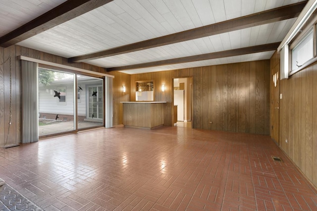 534 Grosvener Ln, Elk Grove Village, IL 60007 - unfurnished living room featuring beamed ceiling, wooden walls, and brick patterned flooring
