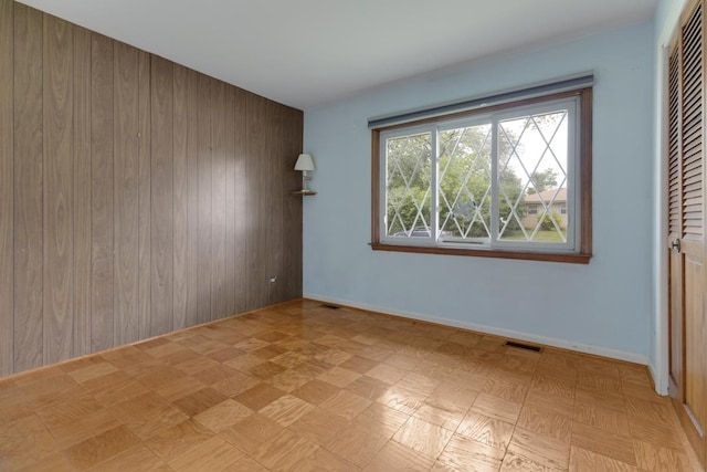 534 Grosvener Ln, Elk Grove Village, IL 60007 - unfurnished bedroom with a closet and wooden walls
