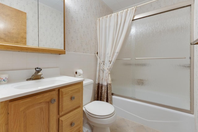 534 Grosvener Ln, Elk Grove Village, IL 60007 - bathroom with wallpapered walls, vanity, shower / bath combination with glass door, tile walls, and a wainscoted wall