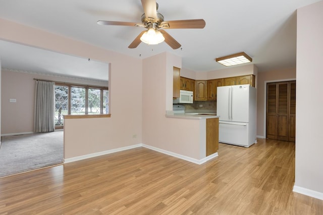 534 Grosvener Ln, Elk Grove Village, IL 60007 - kitchen featuring white appliances, light countertops, brown cabinetry, ceiling fan, and light wood-style floors