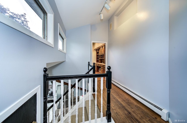 5821 W 127th St, Palos Heights, IL 60463 - stairway featuring a baseboard heating unit, wood finished floors, and rail lighting