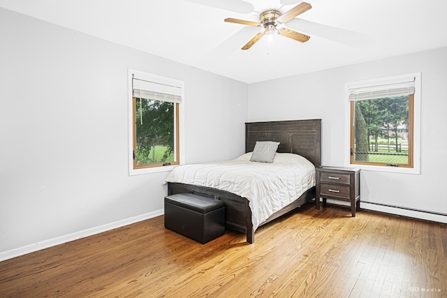 5821 W 127th St, Palos Heights, IL 60463 - bedroom with hardwood / wood-style floors, baseboard heating, and a ceiling fan