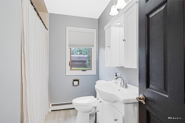 5821 W 127th St, Palos Heights, IL 60463 - full bathroom with a baseboard radiator, vanity, wood finished floors, and curtained shower