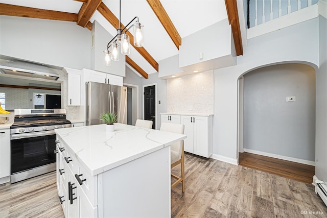 5821 W 127th St, Palos Heights, IL 60463 - kitchen with appliances with stainless steel finishes, arched walkways, high vaulted ceiling, tasteful backsplash, and a center island