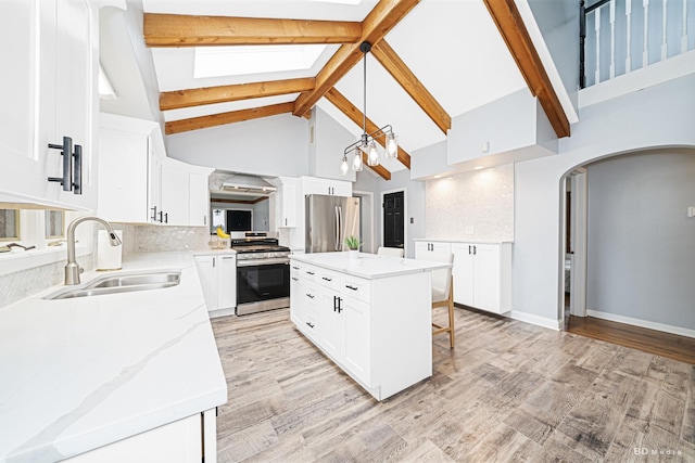 5821 W 127th St, Palos Heights, IL 60463 - kitchen featuring appliances with stainless steel finishes, high vaulted ceiling, arched walkways, decorative backsplash, and beamed ceiling