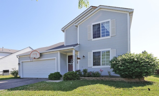 2227 N Quaker Hollow Ln, Round Lake Beach, IL 60073 - traditional-style house with driveway, a garage, and a front lawn