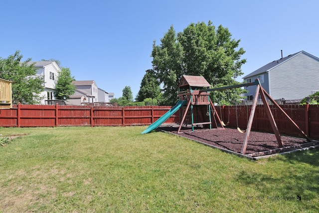2227 N Quaker Hollow Ln, Round Lake Beach, IL 60073 - fenced backyard featuring a playground and a residential view