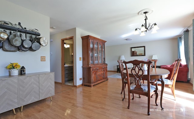 2227 N Quaker Hollow Ln, Round Lake Beach, IL 60073 - dining area featuring a chandelier and light wood-style flooring