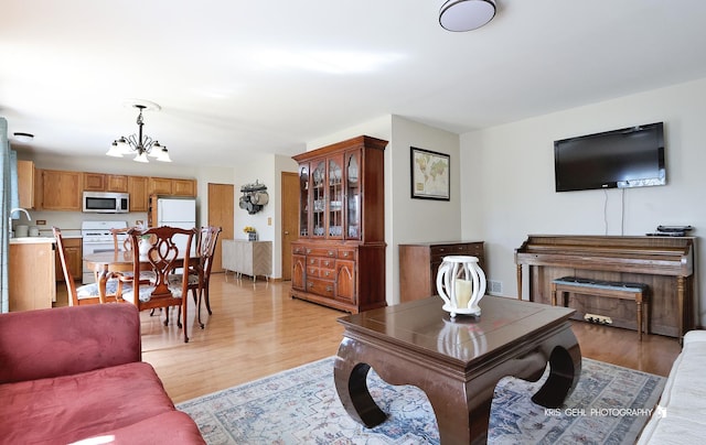 2227 N Quaker Hollow Ln, Round Lake Beach, IL 60073 - living room featuring a chandelier and light wood finished floors