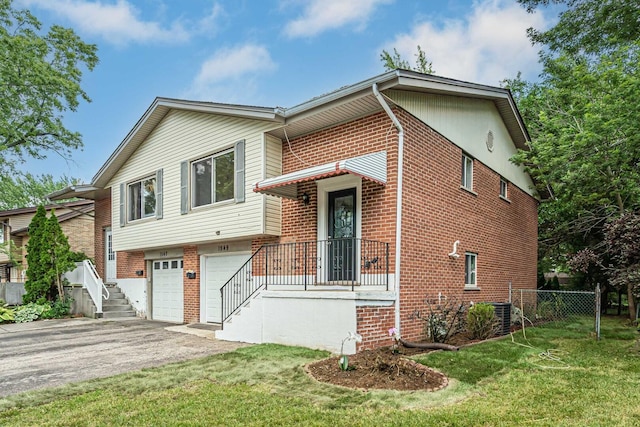 1549 Revere Cir, Schaumburg, IL 60193 - tri-level home featuring asphalt driveway, brick siding, and a garage