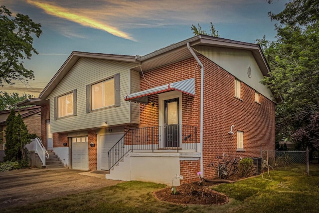 1549 Revere Cir, Schaumburg, IL 60193 - tri-level home featuring brick siding, an attached garage, driveway, and stairs