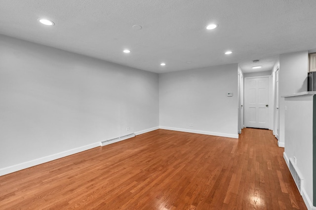 1549 Revere Cir, Schaumburg, IL 60193 - unfurnished room with light wood-style flooring, a baseboard radiator, recessed lighting, and a textured ceiling