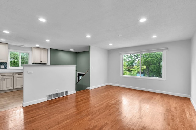 1549 Revere Cir, Schaumburg, IL 60193 - unfurnished living room featuring recessed lighting and light wood finished floors