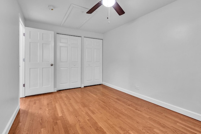 1549 Revere Cir, Schaumburg, IL 60193 - unfurnished bedroom featuring light wood-style flooring, two closets, attic access, and ceiling fan