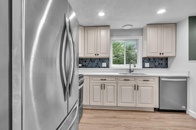 1549 Revere Cir, Schaumburg, IL 60193 - kitchen with stainless steel appliances, decorative backsplash, light countertops, light wood-style floors, and recessed lighting
