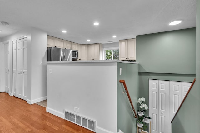 1549 Revere Cir, Schaumburg, IL 60193 - kitchen with freestanding refrigerator, light wood-type flooring, recessed lighting, and cream cabinets