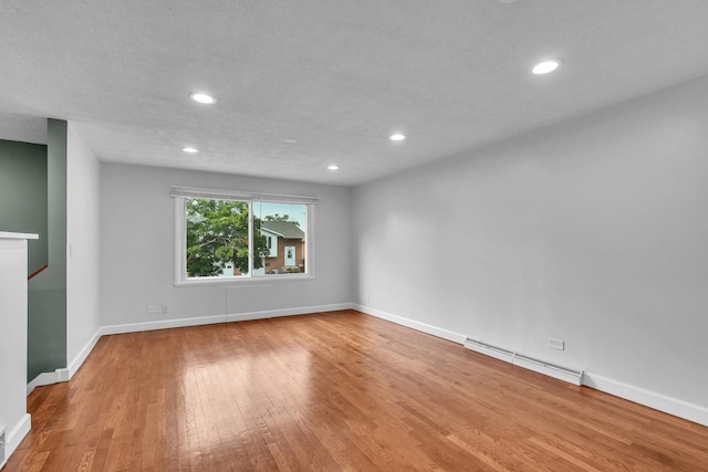 1549 Revere Cir, Schaumburg, IL 60193 - unfurnished room featuring a baseboard heating unit, wood finished floors, and recessed lighting