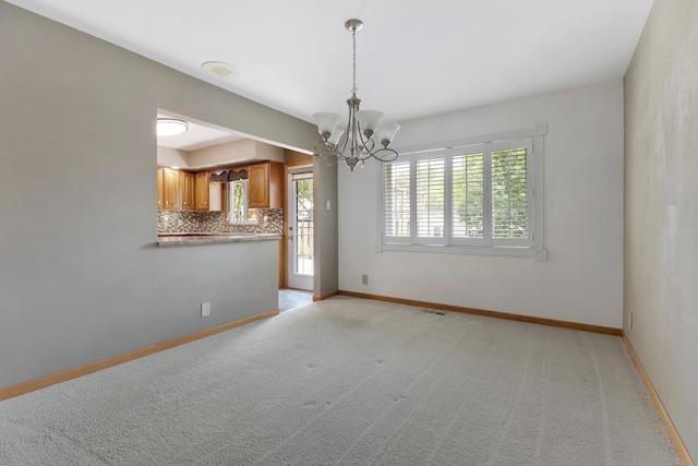 215 S Park Blvd, Streamwood, IL 60107 - empty room featuring a chandelier and light colored carpet