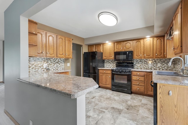 215 S Park Blvd, Streamwood, IL 60107 - kitchen featuring black appliances, a peninsula, light countertops, and tasteful backsplash