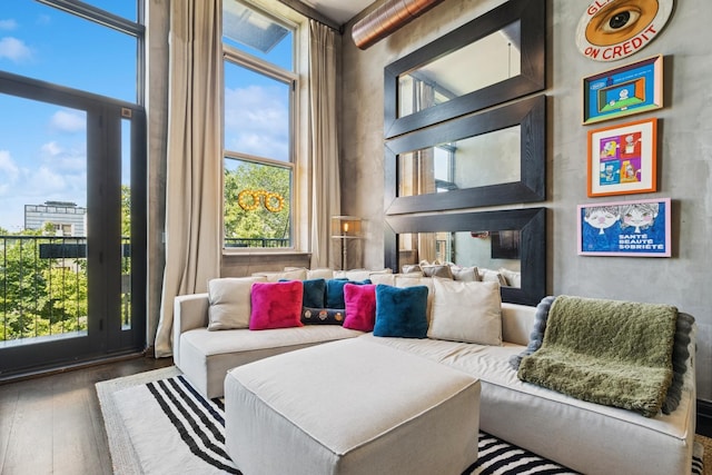 1215 W Gunnison St Unit 202, Chicago, IL 60640 - living area with wood-type flooring, plenty of natural light, and a towering ceiling