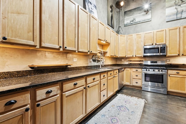 1215 W Gunnison St Unit 202, Chicago, IL 60640 - kitchen with appliances with stainless steel finishes, light brown cabinetry, dark wood-type flooring, a high ceiling, and dark stone countertops