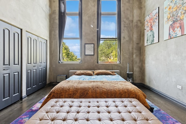 1215 W Gunnison St Unit 202, Chicago, IL 60640 - bedroom featuring dark wood-style flooring and two closets