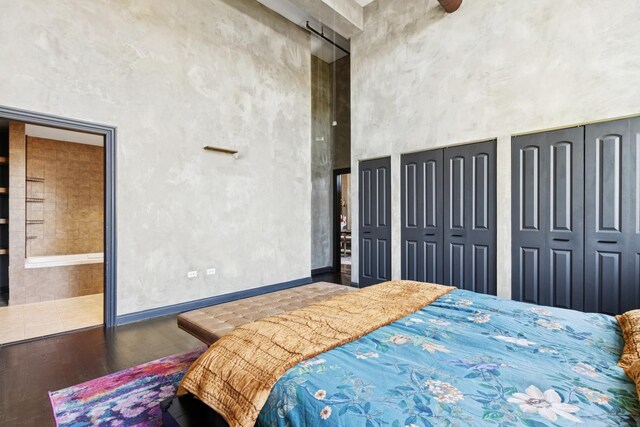 1215 W Gunnison St Unit 202, Chicago, IL 60640 - bedroom featuring wood finished floors, a high ceiling, and two closets