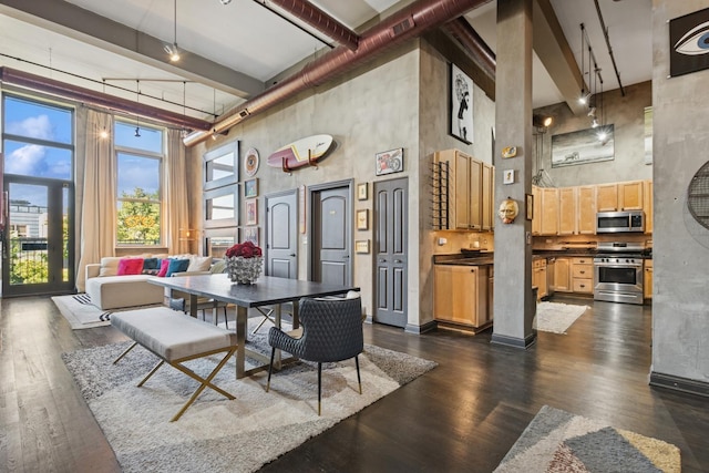 1215 W Gunnison St Unit 202, Chicago, IL 60640 - dining area featuring a high ceiling and dark wood-style flooring