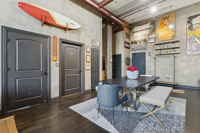 1215 W Gunnison St Unit 202, Chicago, IL 60640 - dining space featuring a towering ceiling and dark wood-type flooring