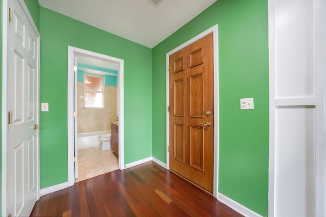 3002 W Montrose Ave Unit 2A, Chicago, IL 60618 - foyer entrance featuring baseboards and dark wood-style flooring