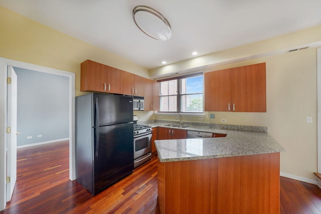 3002 W Montrose Ave Unit 2A, Chicago, IL 60618 - kitchen featuring stainless steel appliances, a peninsula, light stone counters, dark wood-type flooring, and brown cabinets