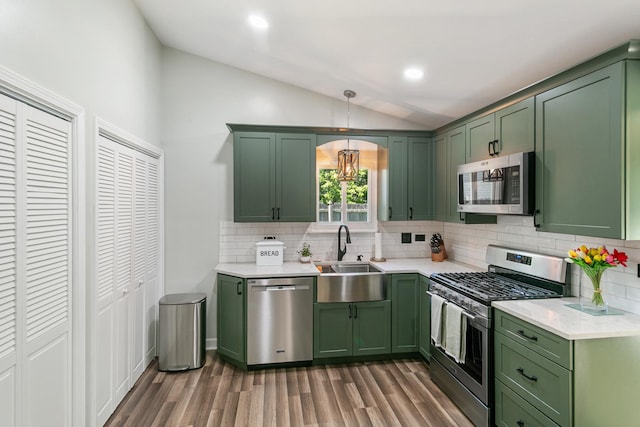 895 Fieldside Ln, Aurora, IL 60504 - kitchen with green cabinetry, appliances with stainless steel finishes, lofted ceiling, wood finished floors, and recessed lighting