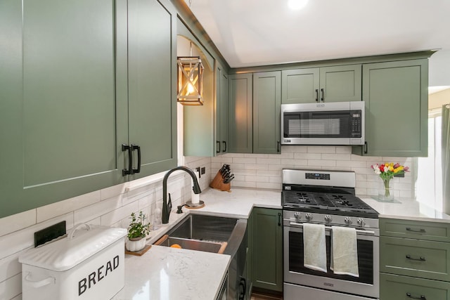 895 Fieldside Ln, Aurora, IL 60504 - kitchen featuring green cabinets, stainless steel appliances, backsplash, and light stone countertops
