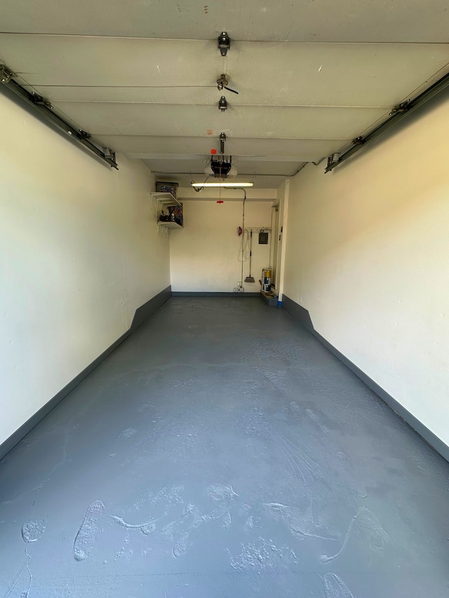 8234 Portsmouth Dr Unit D, Darien, IL 60561 - garage featuring a garage door opener and baseboards