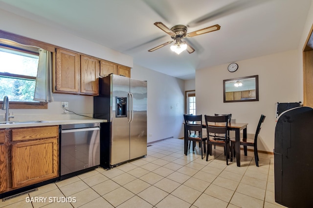 2N436 Bernice Ave, Glen Ellyn, IL 60137 - kitchen featuring stainless steel appliances, a ceiling fan, light countertops, and brown cabinetry