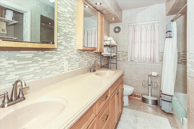 117 N Kenilworth Ave, Mount Prospect, IL 60056 - full bathroom featuring double vanity, tiled shower / bath combo, tile walls, tile patterned floors, and decorative backsplash