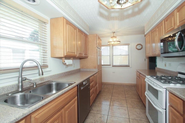 117 N Kenilworth Ave, Mount Prospect, IL 60056 - kitchen featuring stainless steel appliances, a chandelier, light tile patterned flooring, and light countertops