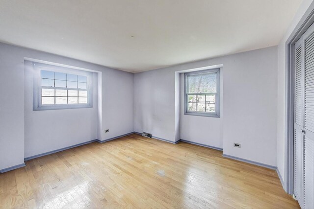 418 Surrey Ln, Lindenhurst, IL 60046 - unfurnished bedroom featuring light wood-type flooring and a closet