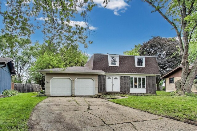 418 Surrey Ln, Lindenhurst, IL 60046 - view of property with brick siding, an attached garage, a front yard, driveway, and mansard roof