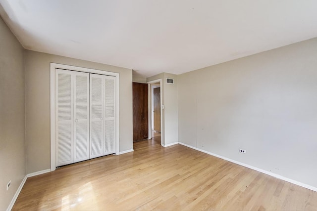 418 Surrey Ln, Lindenhurst, IL 60046 - unfurnished bedroom with light wood finished floors and a closet