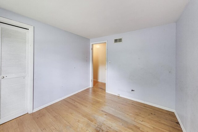 418 Surrey Ln, Lindenhurst, IL 60046 - unfurnished bedroom featuring light wood-style floors and baseboards