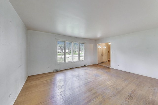 418 Surrey Ln, Lindenhurst, IL 60046 - unfurnished living room with light wood-style flooring and baseboards