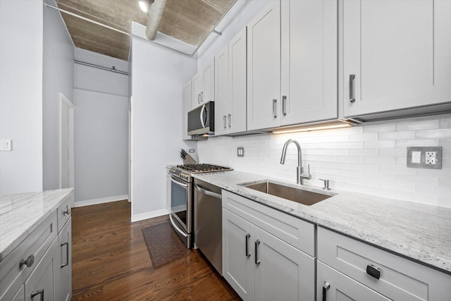 811 W 15th Pl Unit 709, Chicago, IL 60608 - kitchen with stainless steel appliances, dark wood-style flooring, backsplash, and light stone countertops