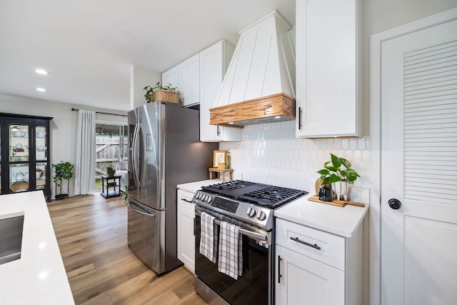 750 Shady Ln, Aurora, IL 60506 - kitchen with custom range hood, stainless steel appliances, light countertops, tasteful backsplash, and light wood-style floors