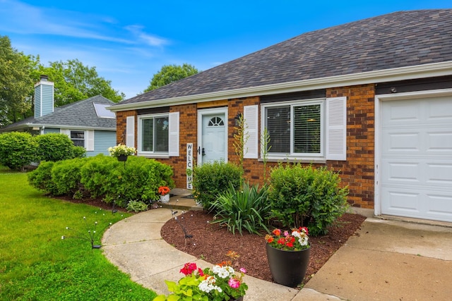 750 Shady Ln, Aurora, IL 60506 - view of front of house featuring brick siding, a front yard, a shingled roof, and a garage