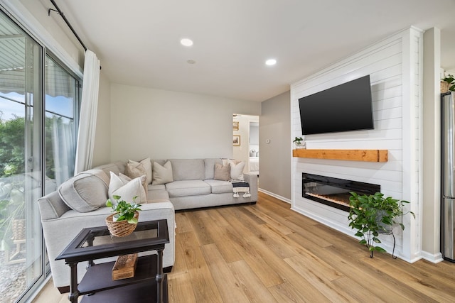 750 Shady Ln, Aurora, IL 60506 - living area featuring light wood-type flooring, recessed lighting, and a glass covered fireplace