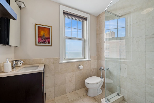 5000 S E End Ave Unit 18C, Chicago, IL 60615 - bathroom with tile walls, vanity, a stall shower, tile patterned flooring, and a wainscoted wall