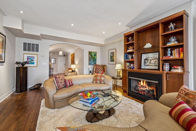 5000 S E End Ave Unit 18C, Chicago, IL 60615 - living room with arched walkways, dark wood-style floors, a glass covered fireplace, and recessed lighting