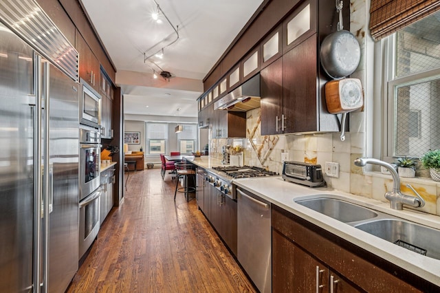 5000 S E End Ave Unit 18C, Chicago, IL 60615 - kitchen with built in appliances, dark wood-style flooring, under cabinet range hood, dark brown cabinetry, and light countertops