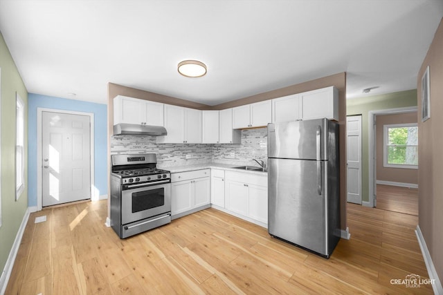 1806 E Sauk Trl, Sauk Village, IL 60411 - kitchen featuring appliances with stainless steel finishes, under cabinet range hood, decorative backsplash, and white cabinetry